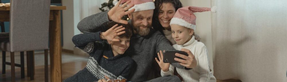 Happy family against the backdrop of a Christmas tree